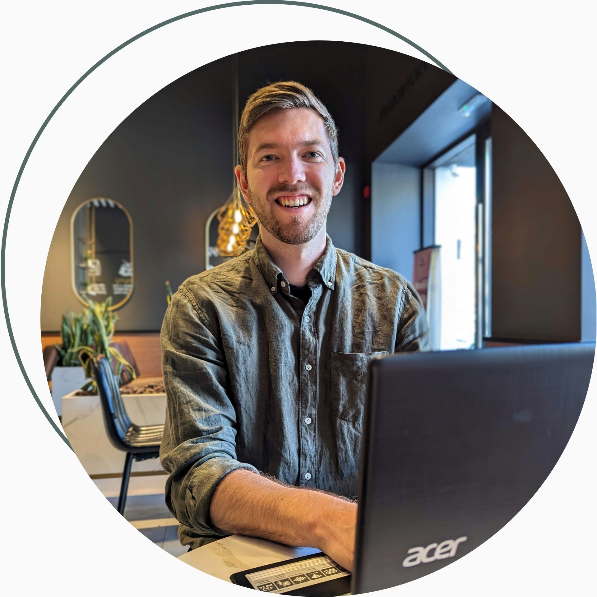 A man sitting in a cafe working on a laptop
